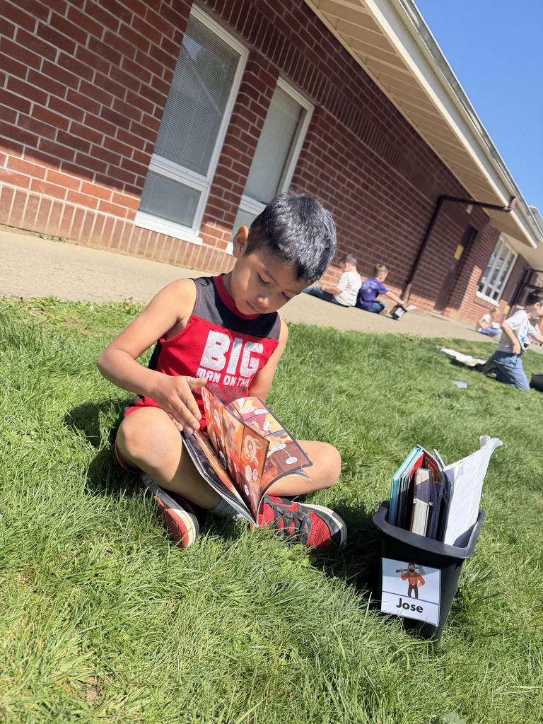 First grade student reading in the sun