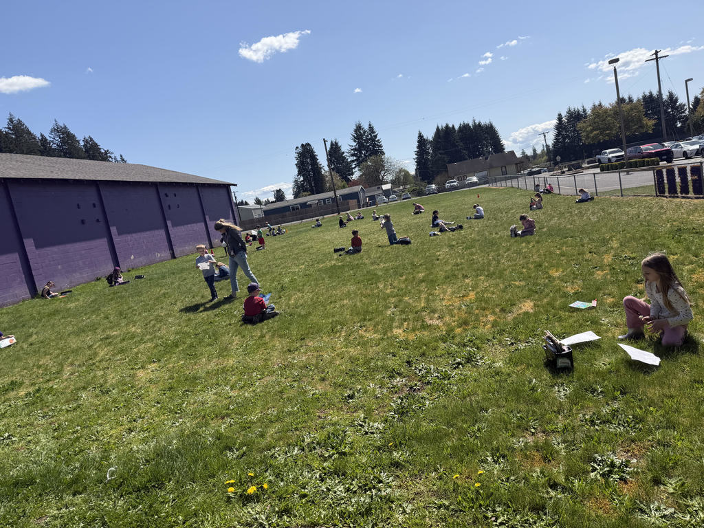 First grade students reading in the sun