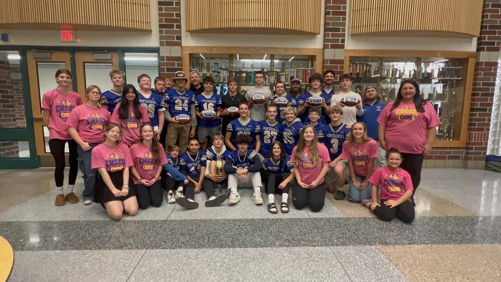 The 2025 Onekama football and cheer teams pose following a 9-0 regular season, longest in school history.