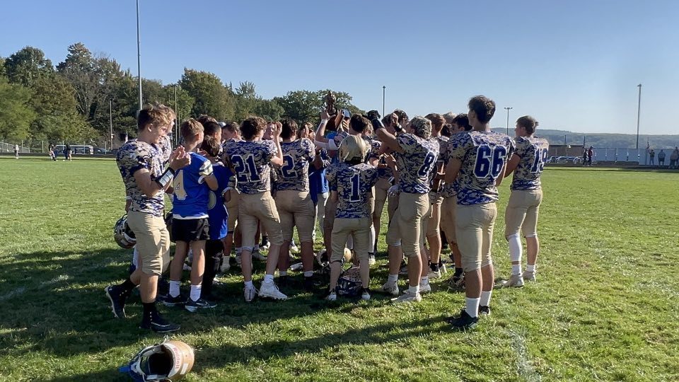 The Onekama football team huddles ahead of a game against Central Lake.