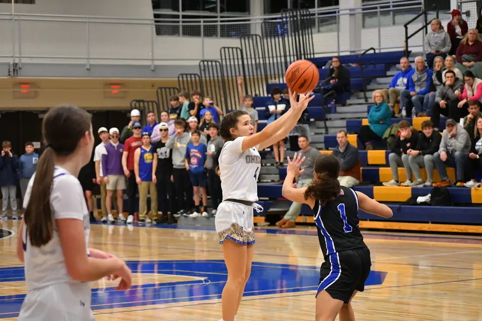 Sophomore Callie Sinke shoots a three-point attempt against Kalkaska on December 15.