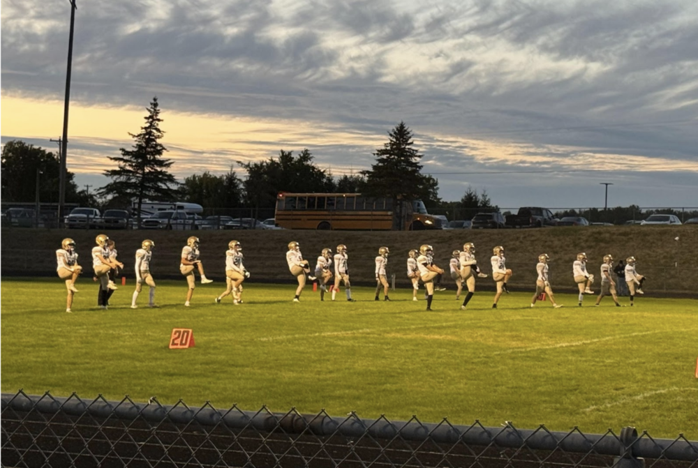 The 2025 Portager football team warms up on the field before playing Marion on September 6.