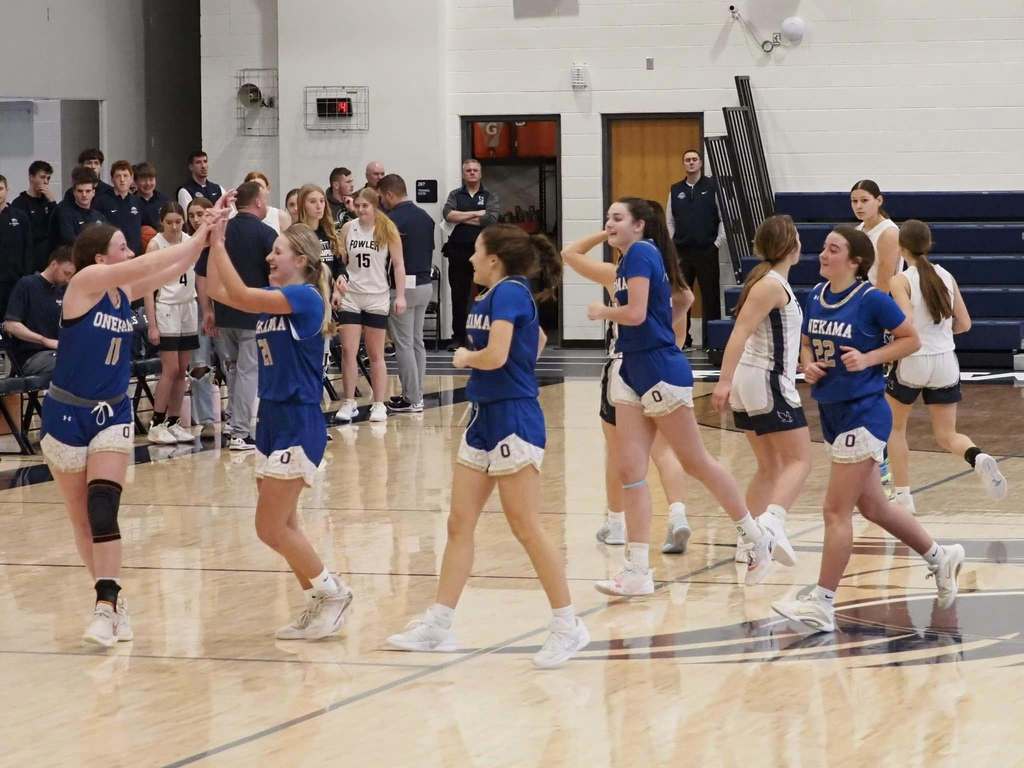 The Onekama girls varsity basketball team meets at midcourt during their opening postseason game against Mesick. (3/4/26 | Credit: Megan McCarthy)