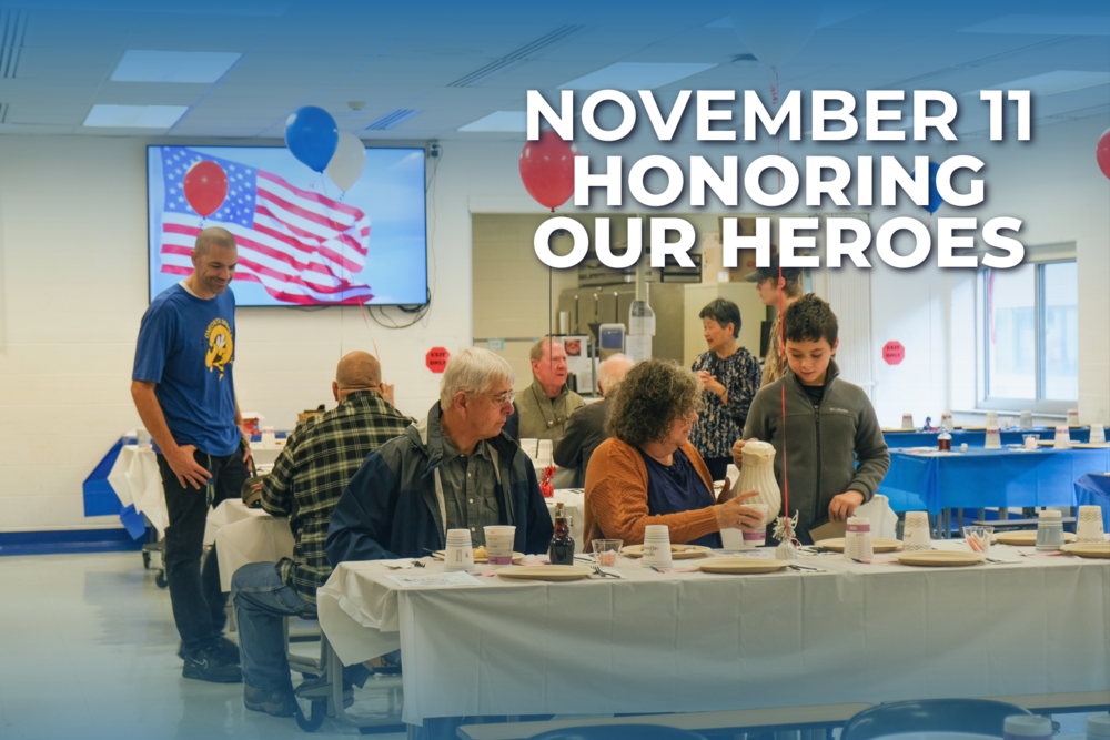 White letters that say November 11 Honoring Our Heroes