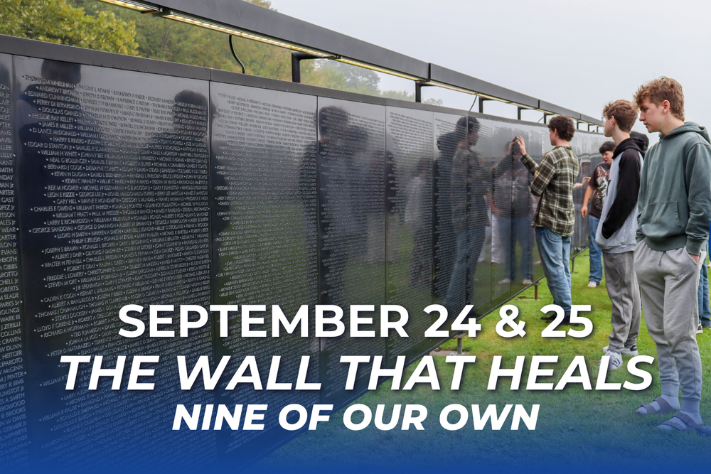 Image of students at a wall with names on it