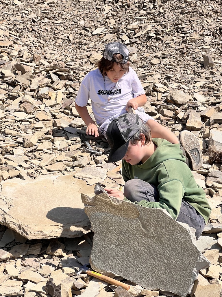 Using a chisel and hammer to separate rock layers