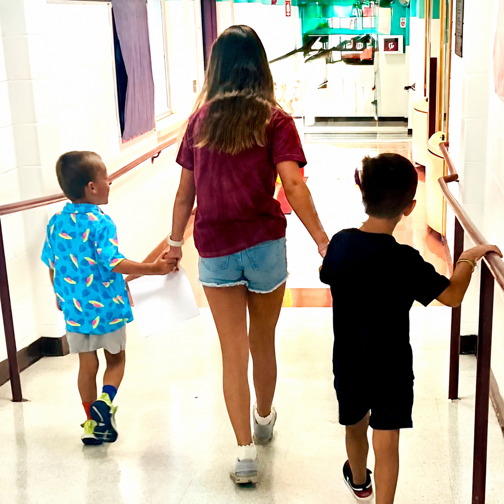 6th grader holding hands with kindergarteners
