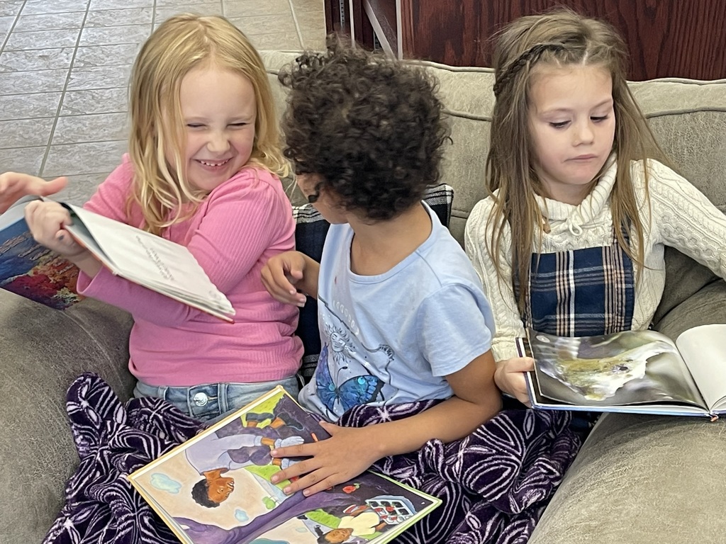three girls looking at a book