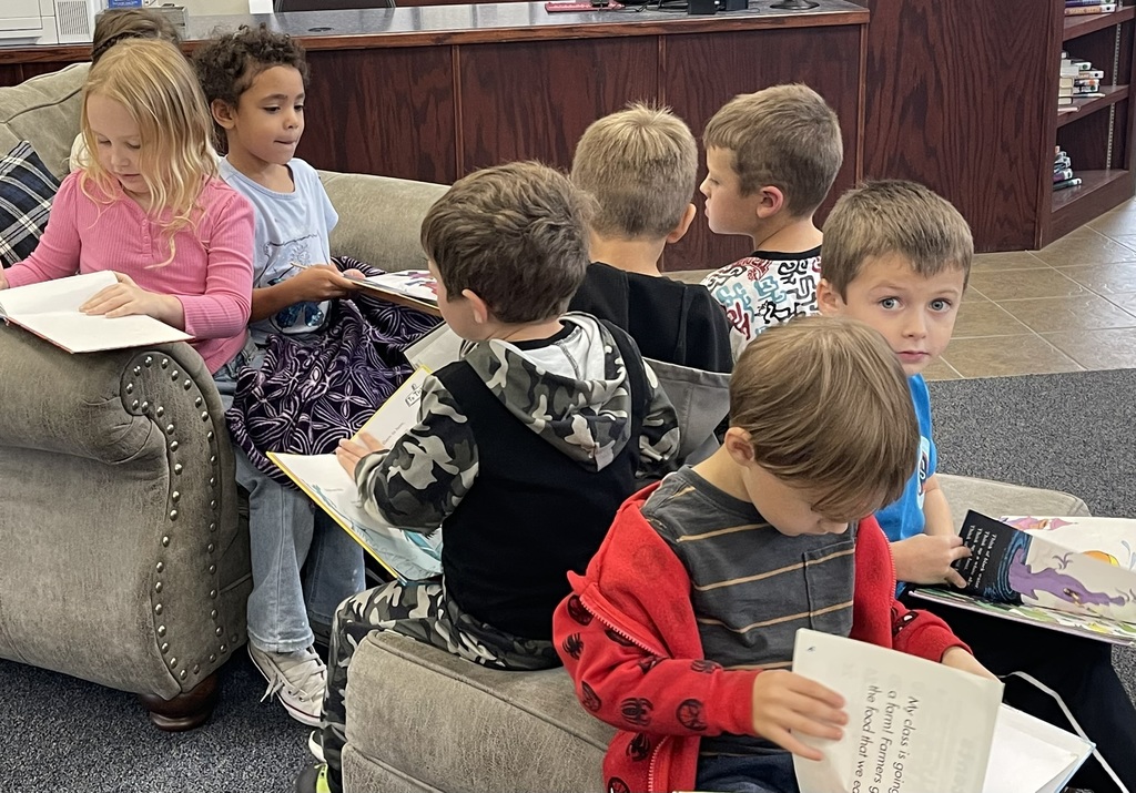kindergarten students looking through their books