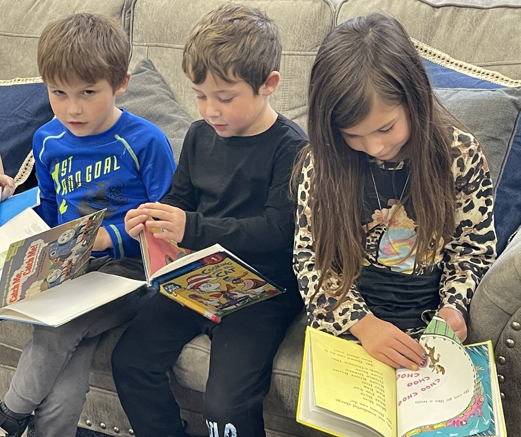kindergarten students looking through their books