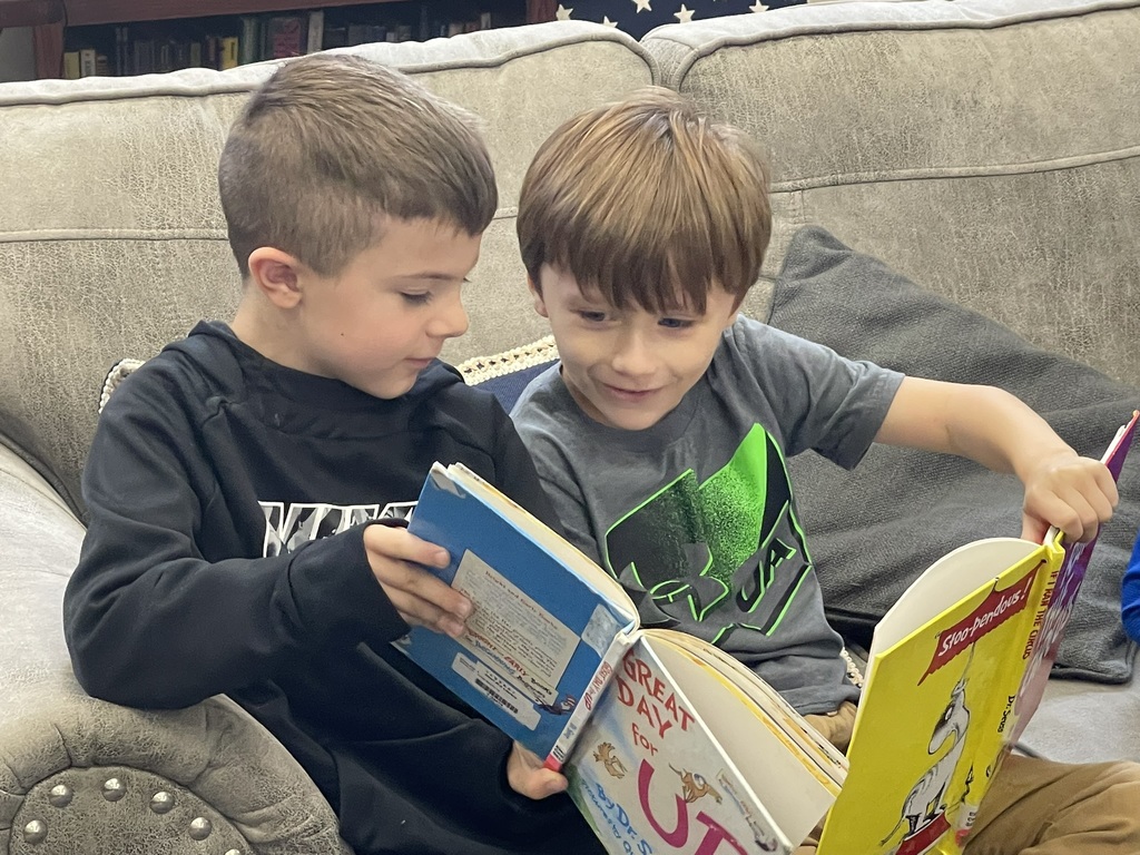two boys looking at a book