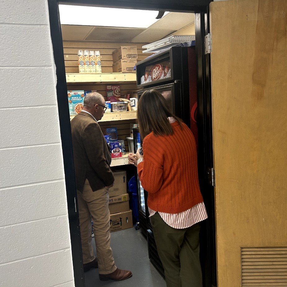 Mrs. Pobst showing Senator Burger the Giving Nest food pantry.