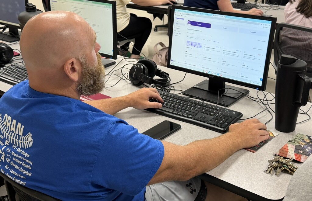 Educator works at a desktop computer exploring the MagicSchool AI platform during a hands-on training session.
