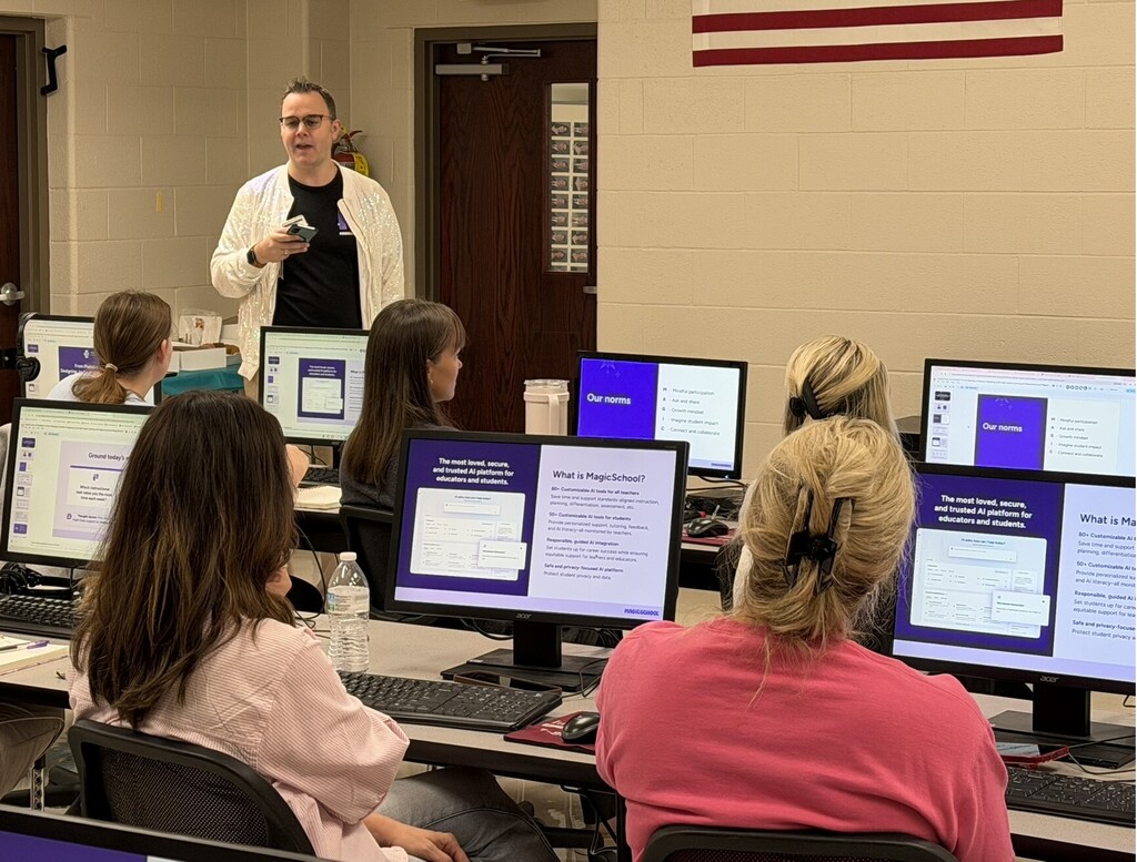 Presenter leads an educator training session as participants follow a MagicSchool AI presentation on desktop computers