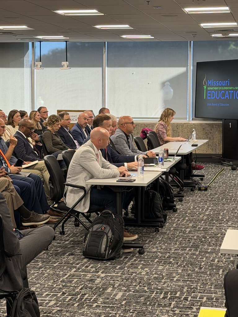 Attendees seated at tables during a Missouri Department of Elementary and Secondary Education meeting.