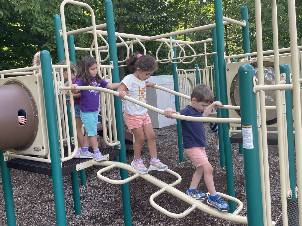 3 kids playing on a playground
