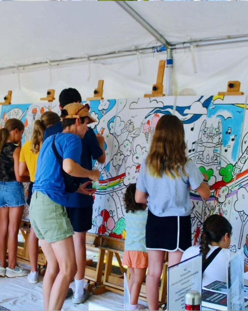 Community members paint a mural