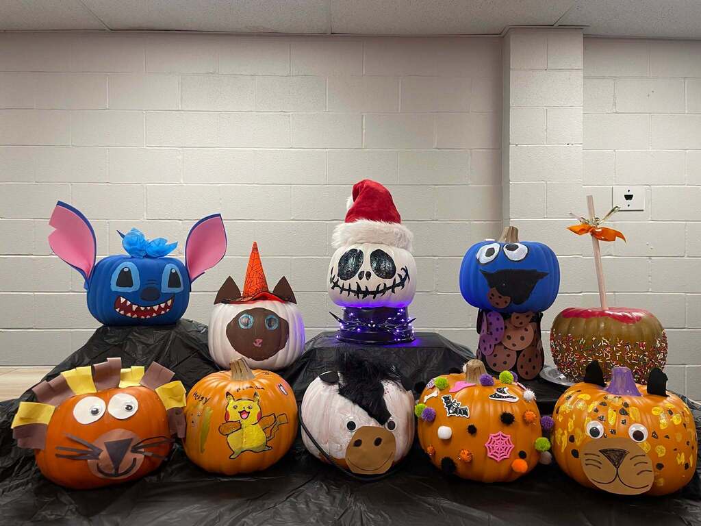 A group of pumpkins decorated to look like different things