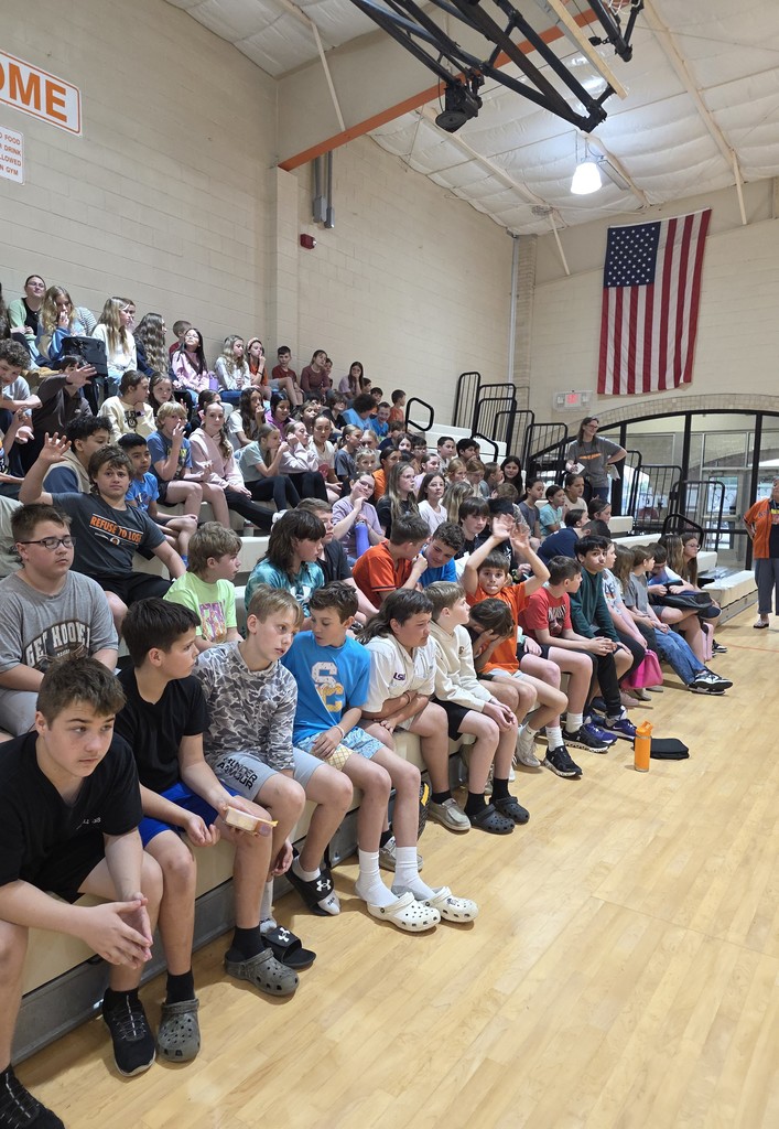 6th grade students watch as the two finalist for the march mathness competition compete in the finals.
