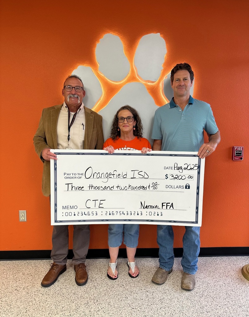 image shows three employees holding a check