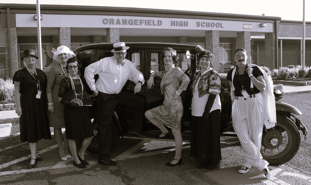staff dressed in 1920s attire by car