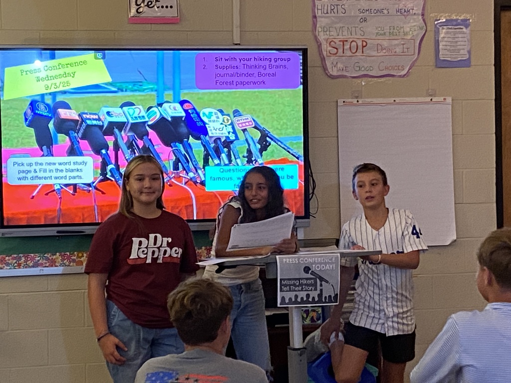 7th grade students giving a "press conference" during ELA class.