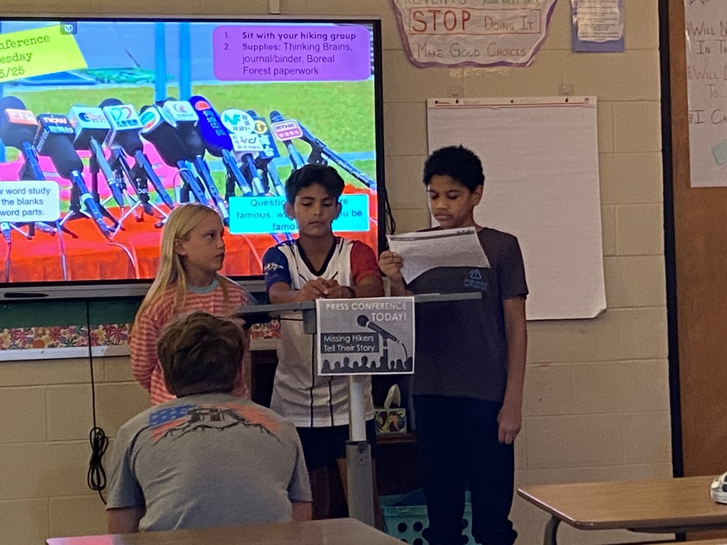 7th grade students giving a "press conference" during ELA class.