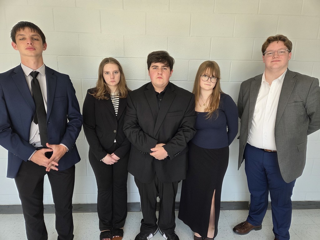 five debate students dressed for competition