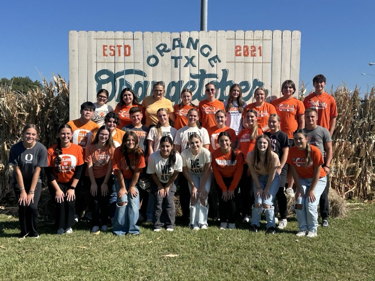 large group of students in front of Orangetober sign