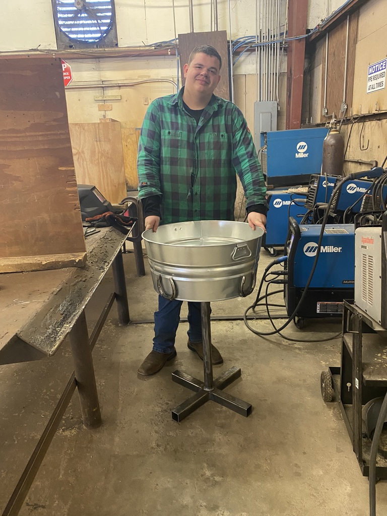 welding student with a trough stand