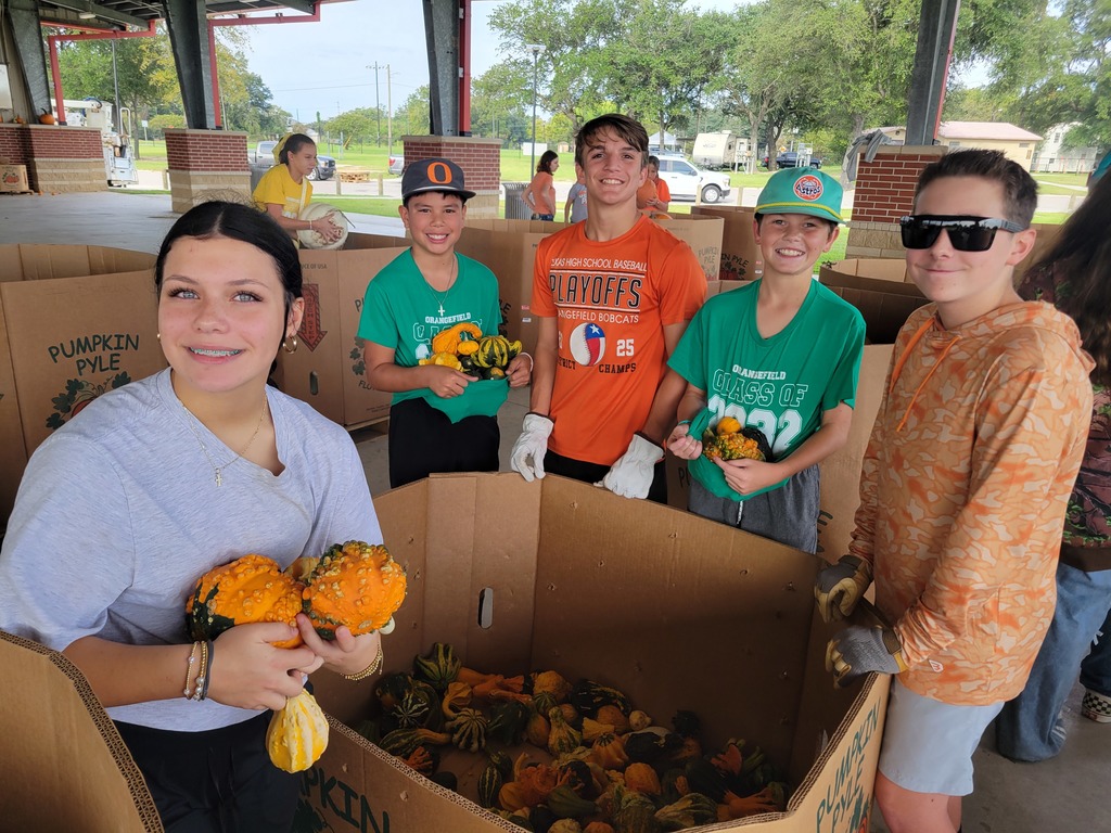 A photo of students setting up for orangetober fest.
