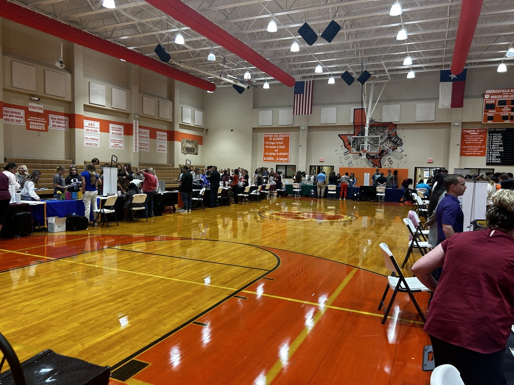 college booths set up in the gym