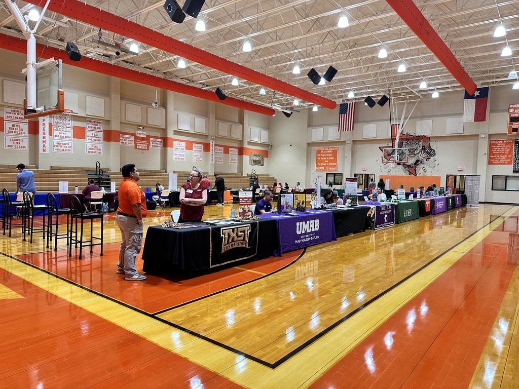 college booths set up in the gym
