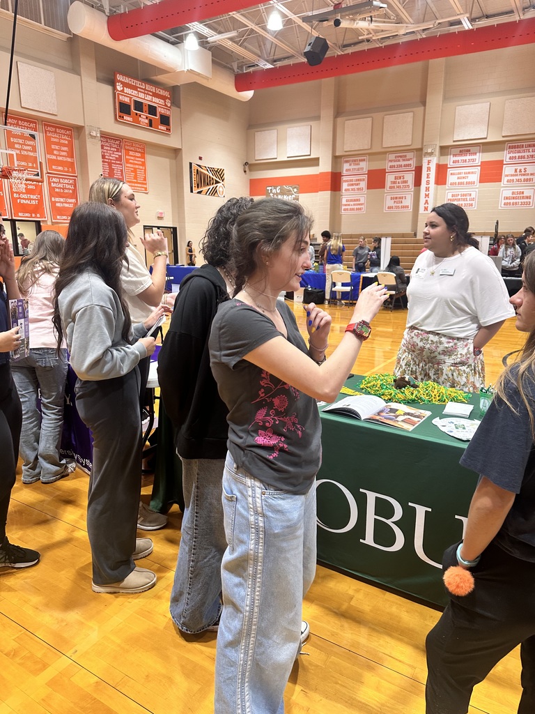 female student visiting with a college recruiter