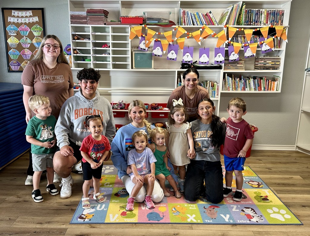 students and children on reading rug