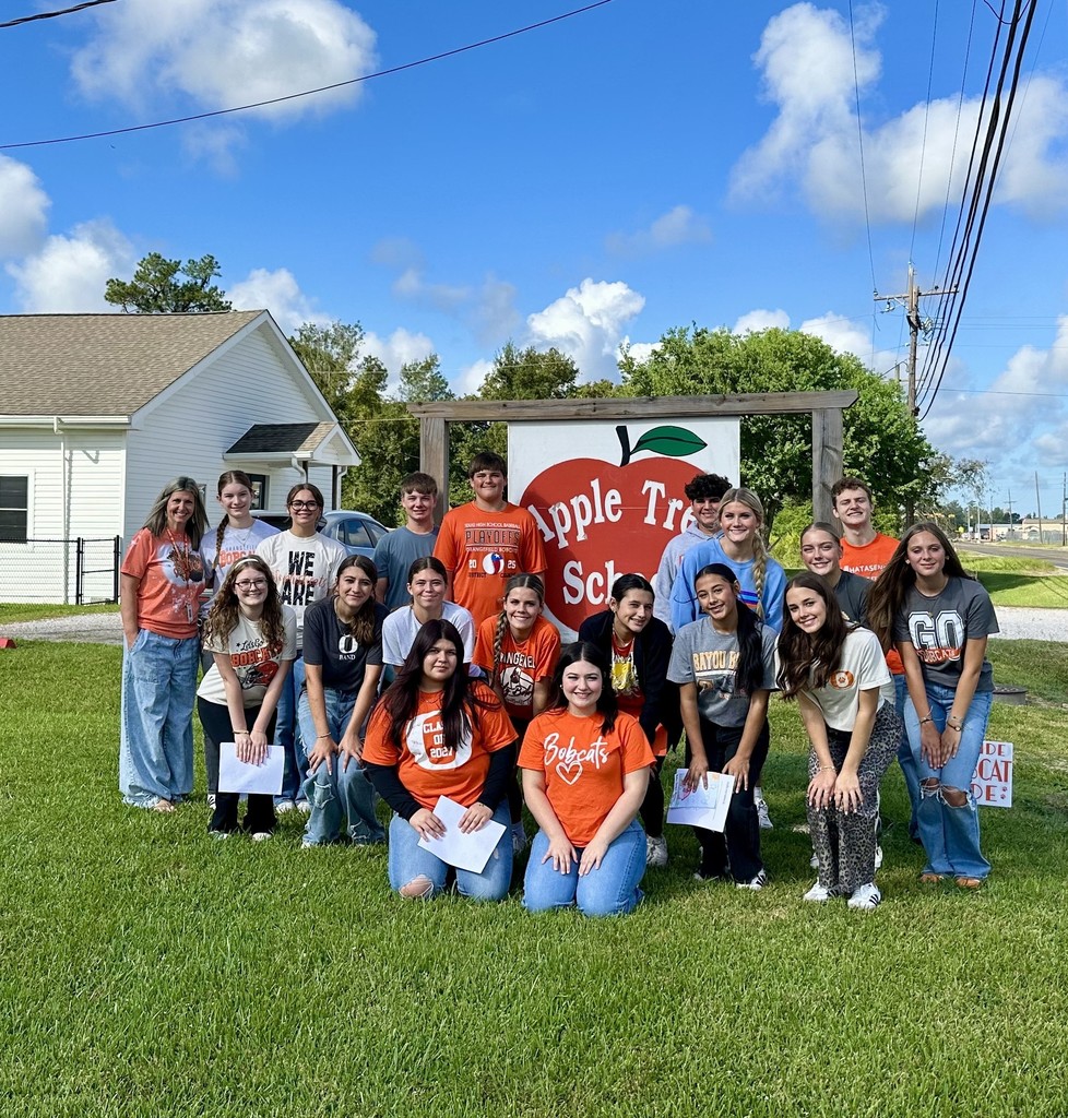 students in front of Apple Tree sign