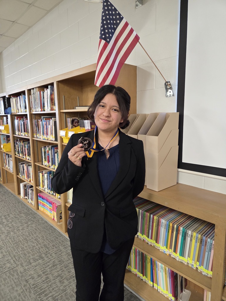student holding a medal