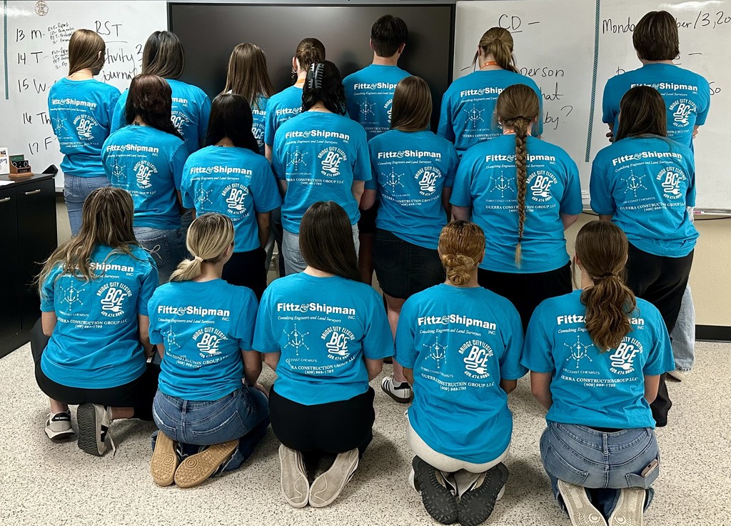 students showing the back of their FCCLA shirts with sponsors logos