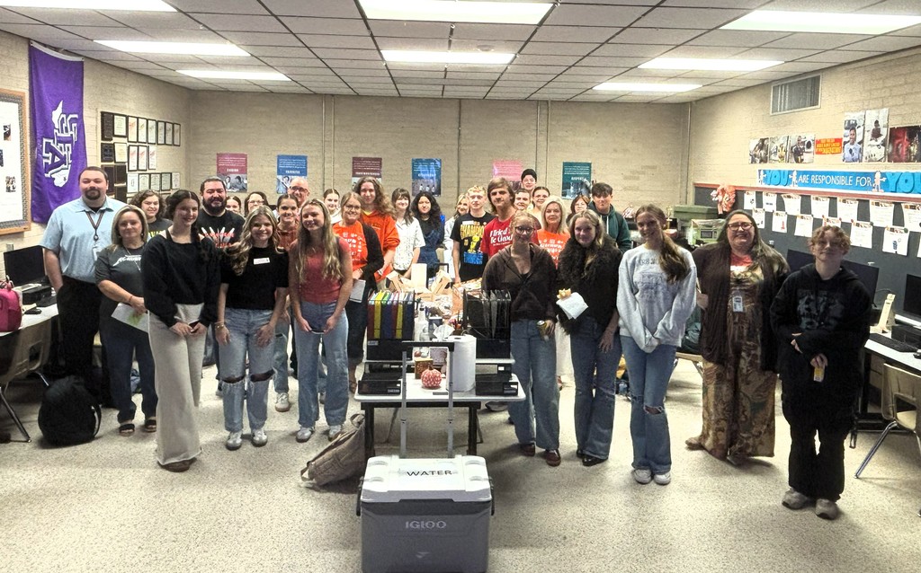 students and teachers standing in a classroom