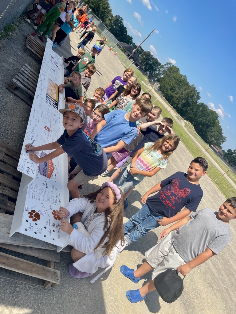Students signing the beam