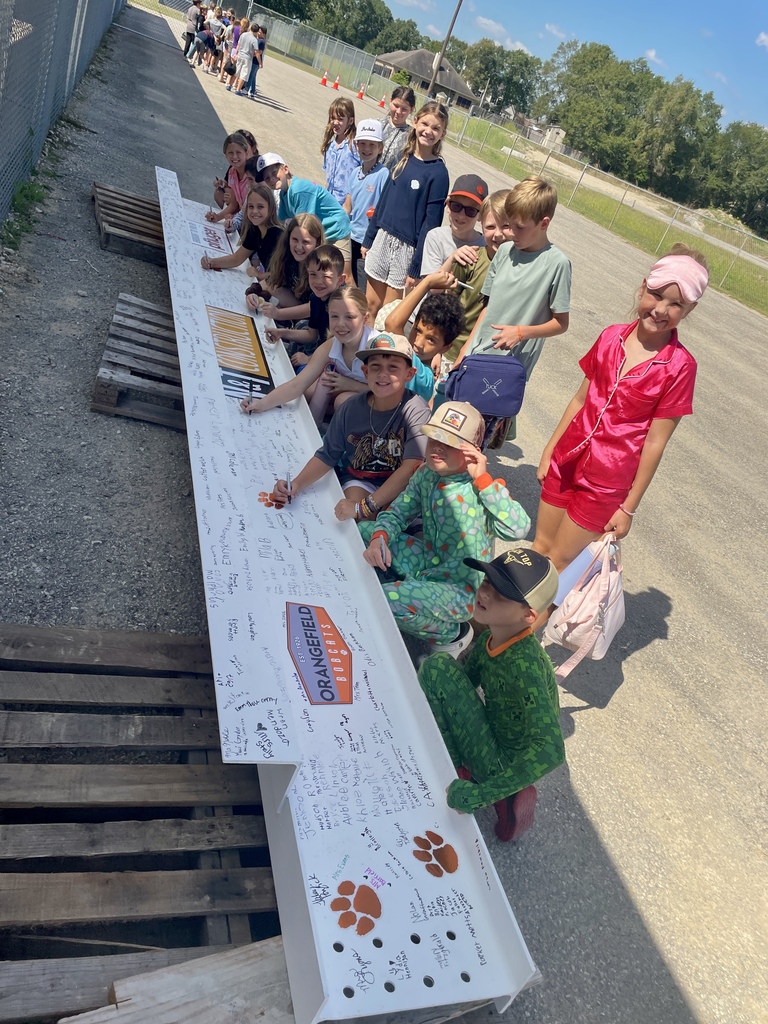 Students signing the beam