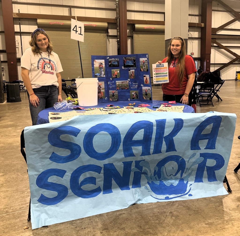two students with soak a senior blue poster