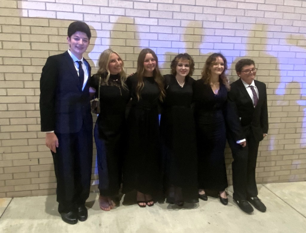 six students dressed in black