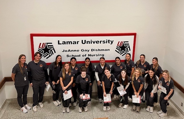 students and instructor by Lamar University school of nursing sign