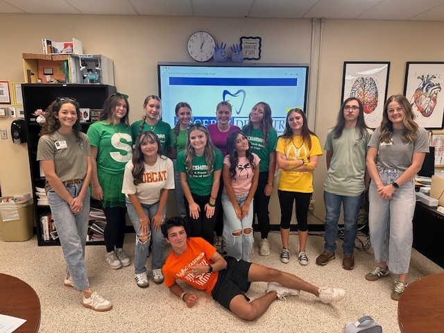 students standing with two guest speakers