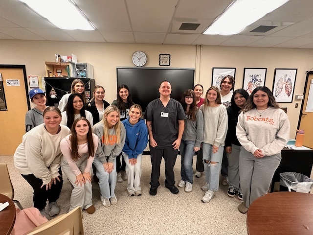 group of students in a classroom with a guest speaker