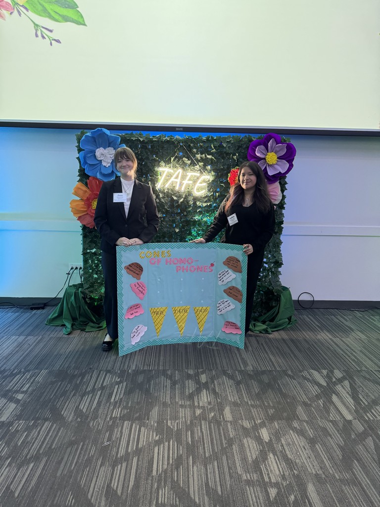 two students with blue bulletin board