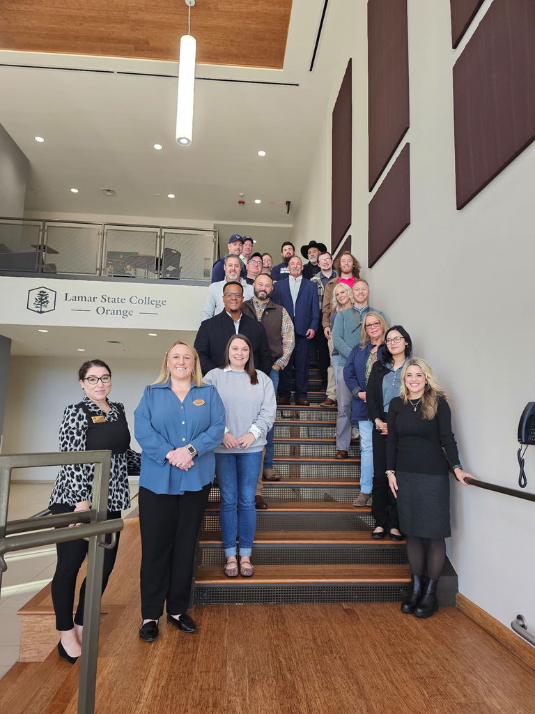 group of adults standing on steps at LSCO