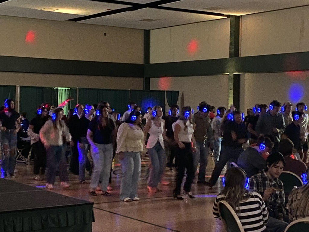 group of students in gym with disco lights