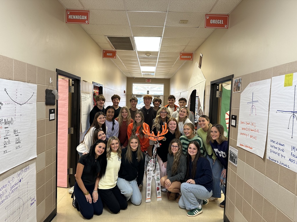students posing with reindeer